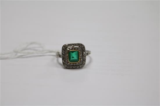 A white metal, emerald and diamond tablet cluster ring, size K.